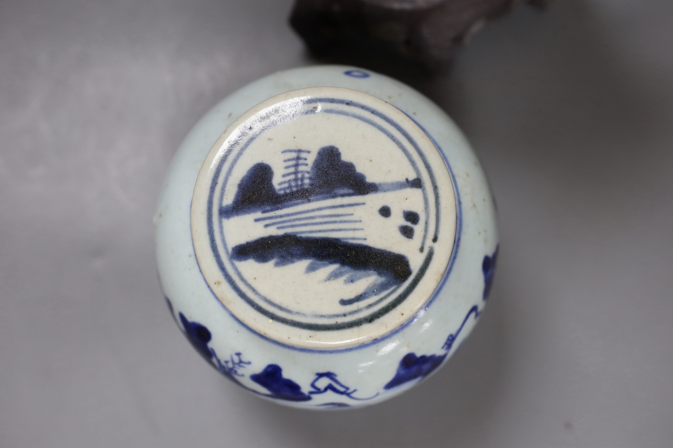 A Chinese soapstone carving of a deity and a similar early 19th century blue and white jar, tallest 30cm